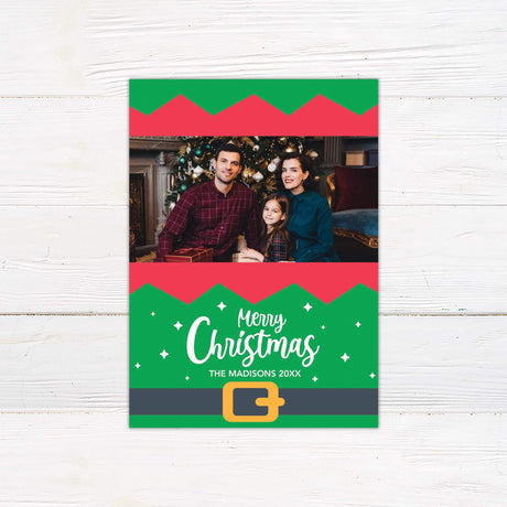 Whimsical Christmas photo card with red and green elf design, personalized with family photo and Santa belt graphic.