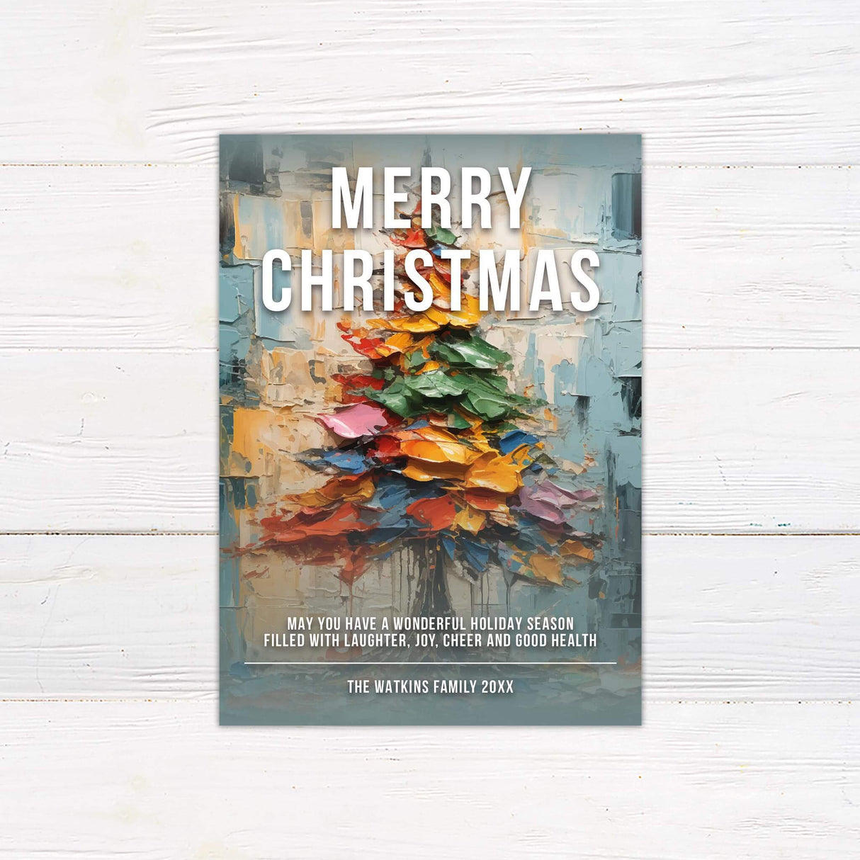 Holiday card with an abstract colorful Christmas tree and bold text reading “Merry Christmas.”
A festive Christmas card featuring modern artwork of a painted tree with space for a personalized family name.