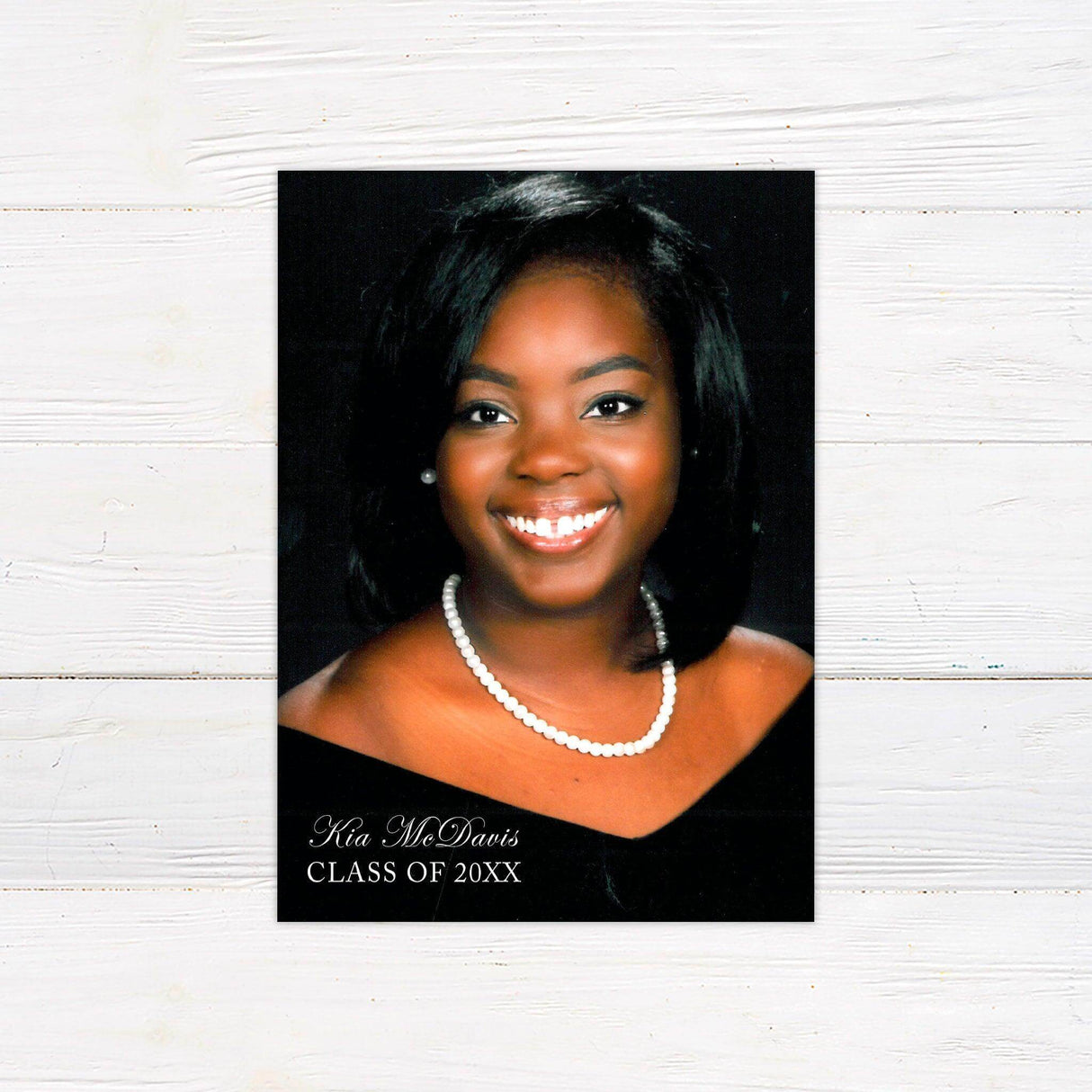 Elegant senior portrait graduation announcement featuring a full senior photo on one side and custom graduation details on the other. This personalized printed card includes the graduate’s name, class year, school, and event details, making it a stylish keepsake for high school or college graduates.