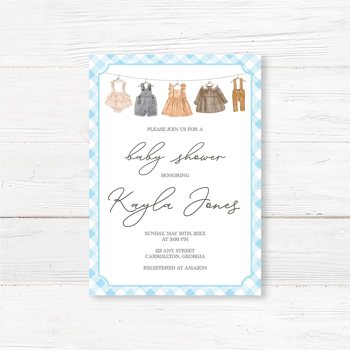 Rustic clothesline baby shower invitation with vintage farmhouse style and blue gingham border, featuring hand-drawn baby clothes.