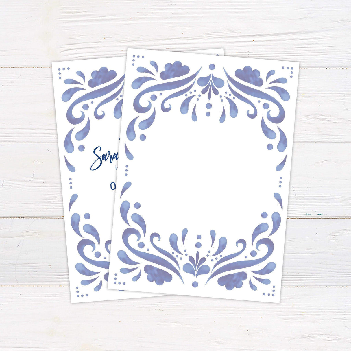 Blue tile-inspired wedding invitation with cobalt watercolor border and modern script typography on a clean white background. back