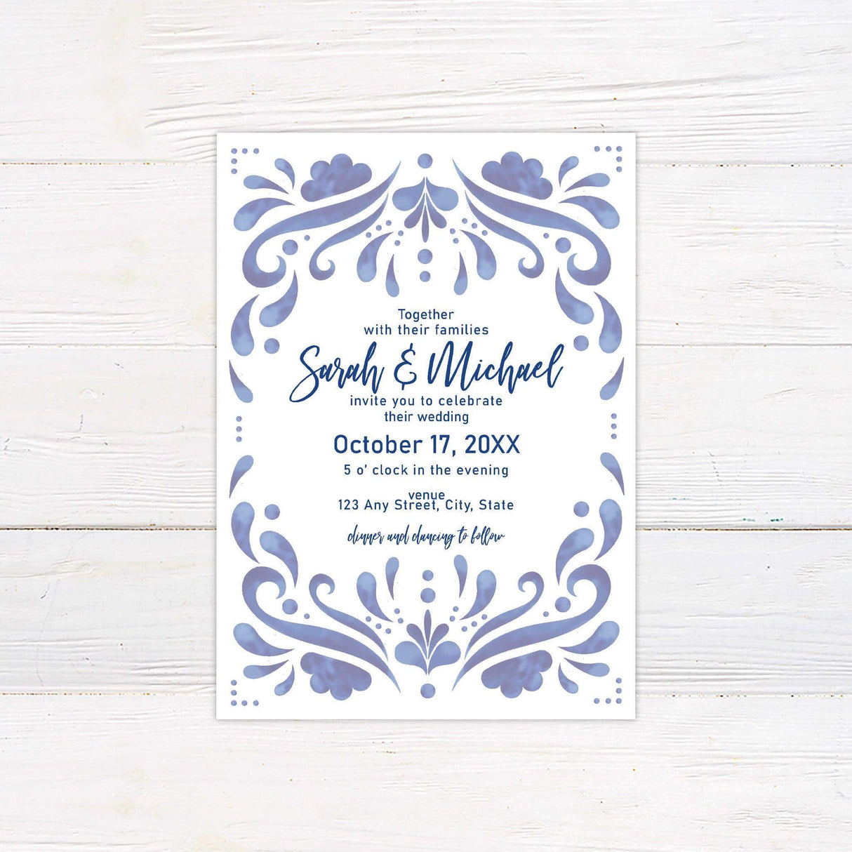 Blue tile-inspired wedding invitation with cobalt watercolor border and modern script typography on a clean white background.