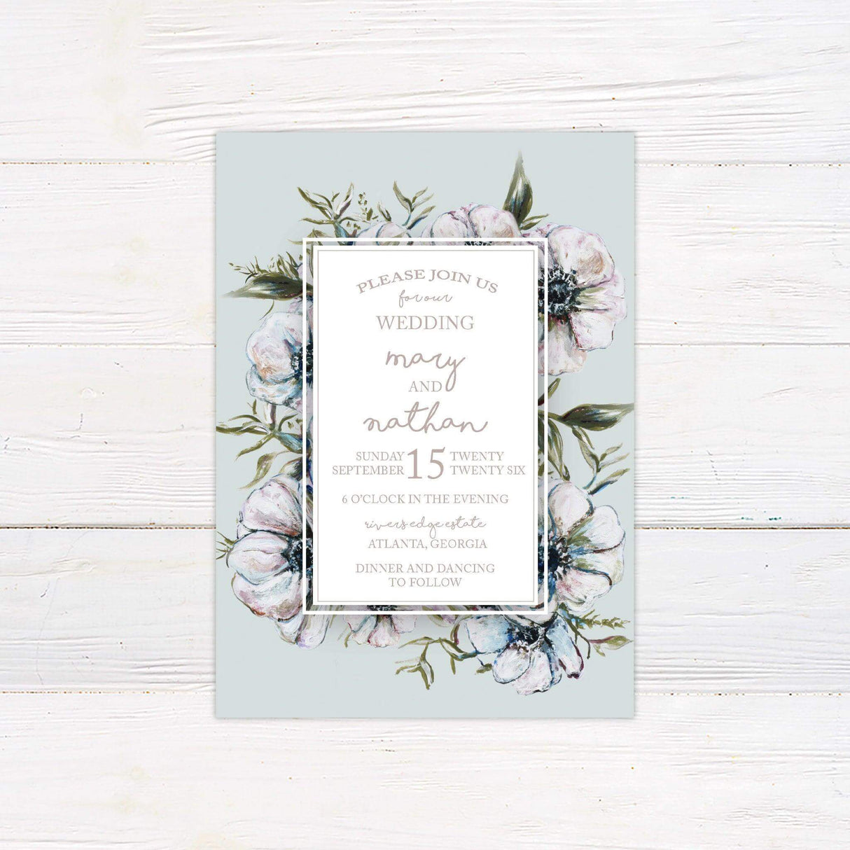 Pastel floral wedding invitation with hand-drawn flower illustrations, light green background, script and serif fonts, and elegant white frame