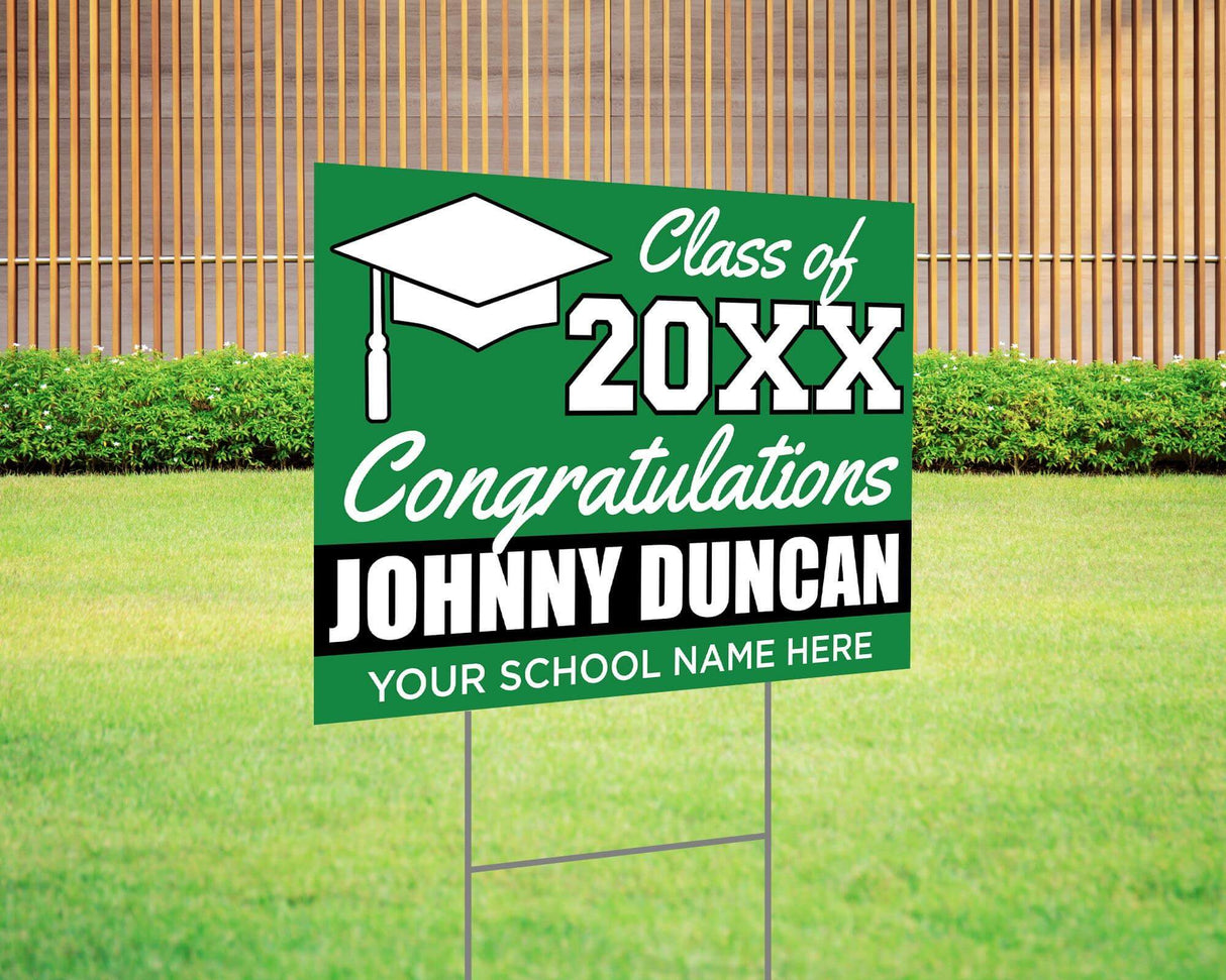 Custom graduation yard sign with bold green and white color block design, featuring a graduation cap graphic, personalized graduate’s name, school, and class year. Printed on durable Coreplast plastic, available in single or double-sided print, perfect for high school and college graduates.
