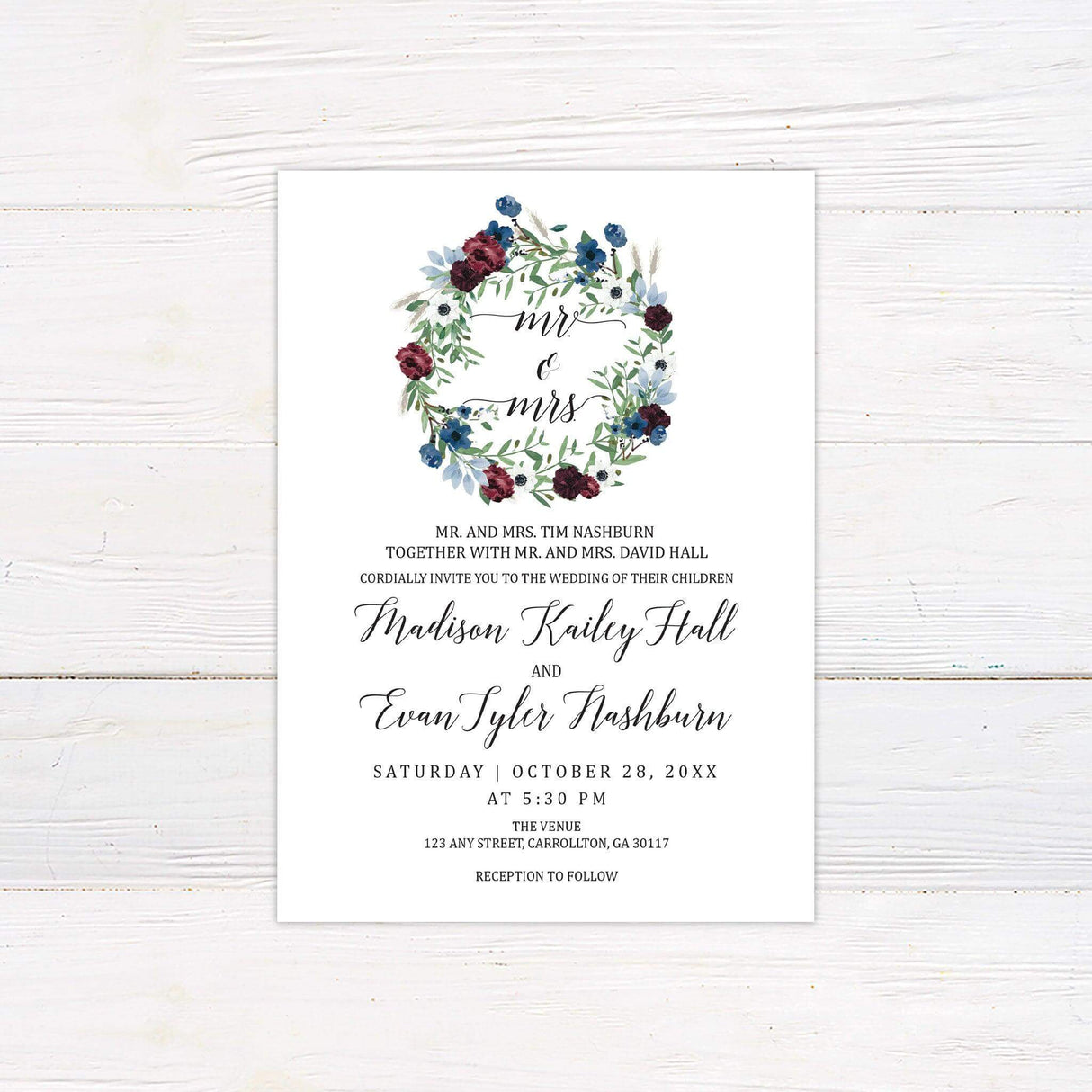 Wedding invitation with watercolor floral wreath in burgundy and blue, elegant script fonts, and classic wedding layout on white background