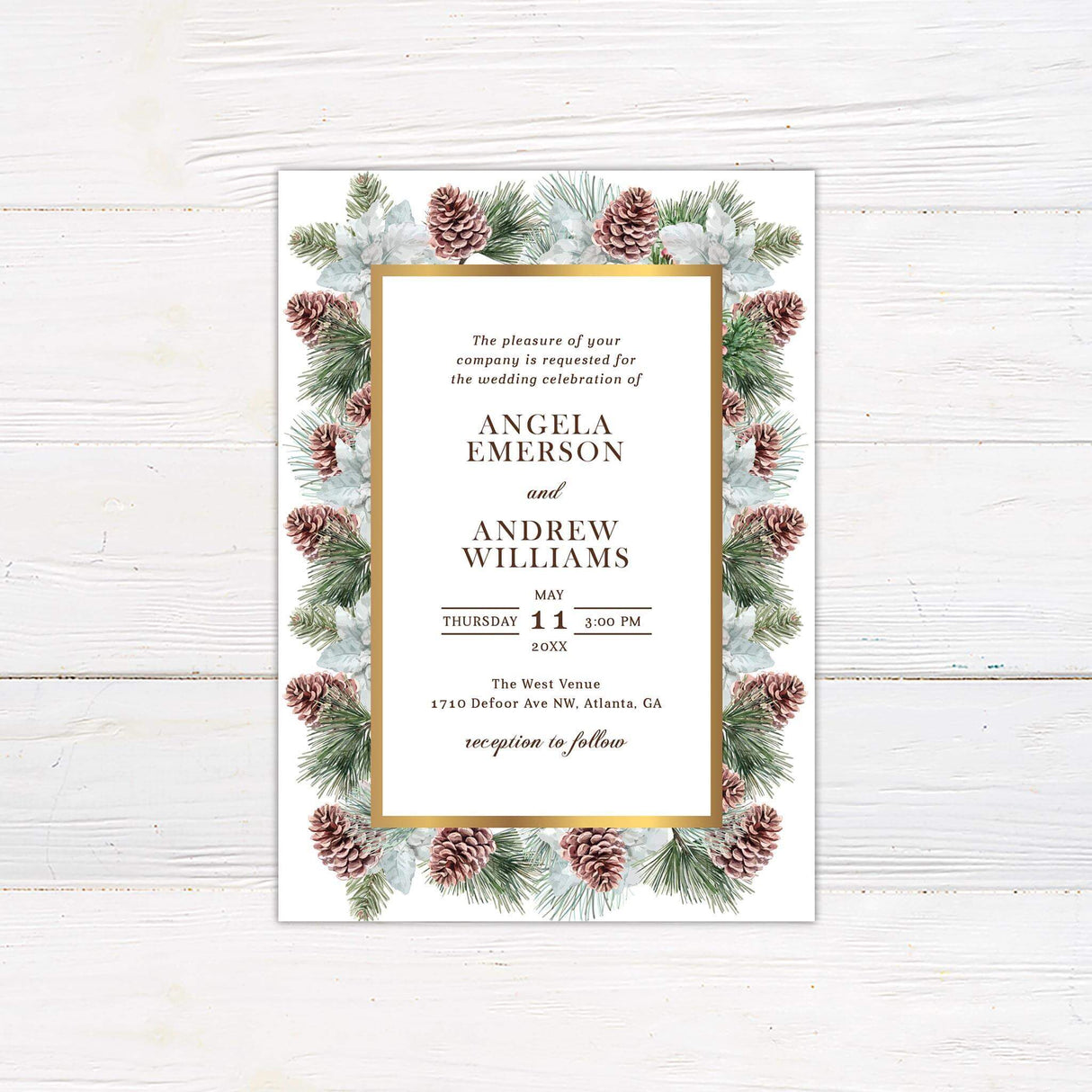 Winter wedding invitation with watercolor pinecones, evergreen branches, white florals, gold frame, and elegant typography on ivory background