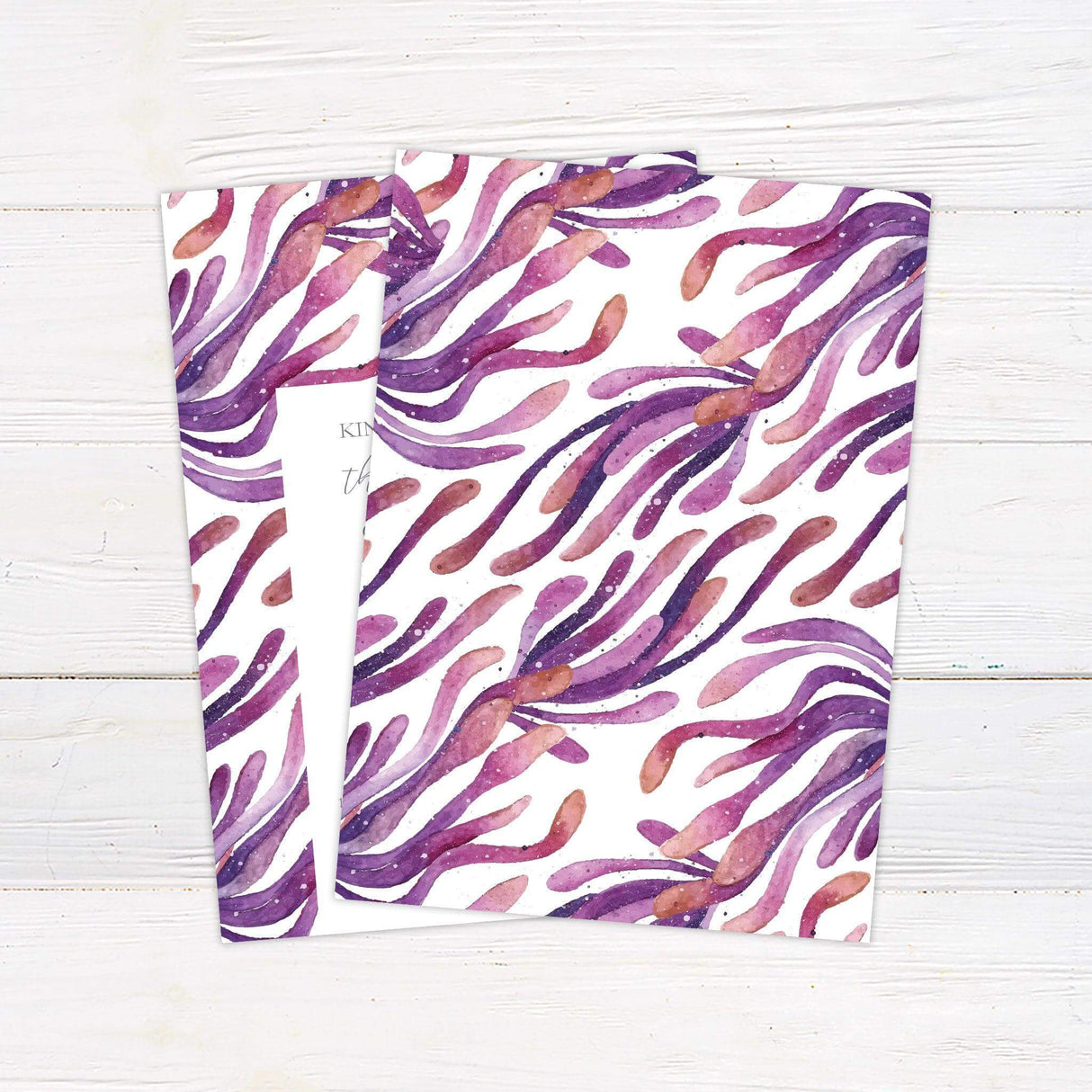 Modern wedding invitation with watercolor brushstrokes in purple, coral, and plum, featuring a central white panel with elegant serif and script text. back