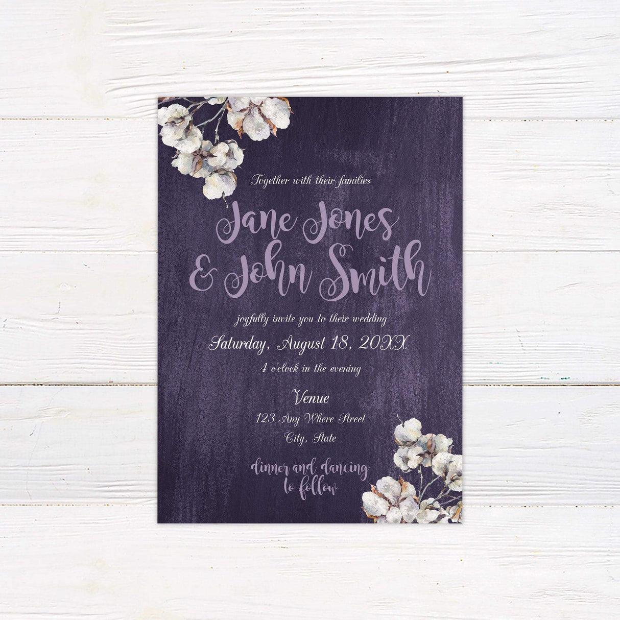 Rustic wedding invitation with purple woodgrain background, watercolor cotton flowers, and whimsical script and serif fonts