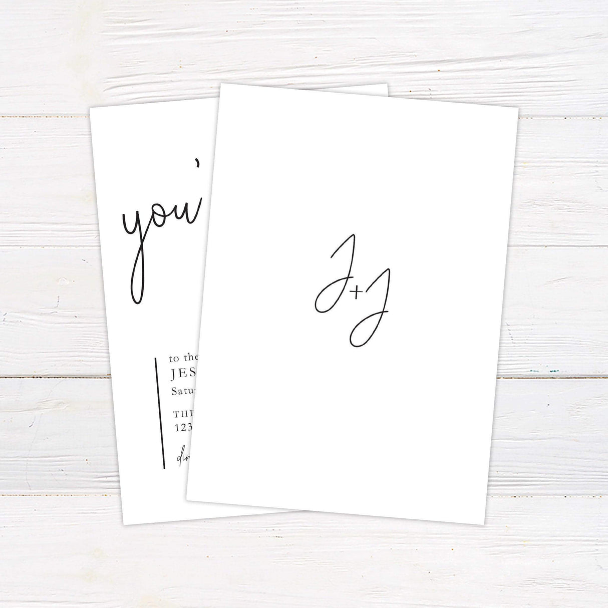 Minimalist wedding invitation with black handwritten script reading "you’re invited" on a white background with modern serif and calligraphy fonts - back