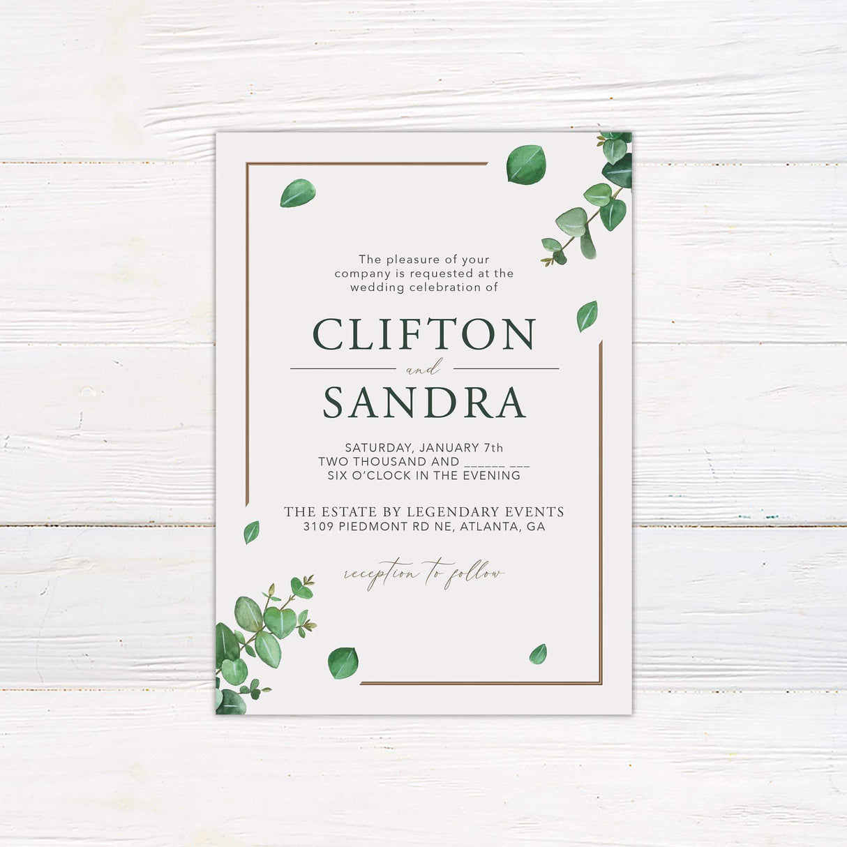 Minimalist eucalyptus wedding invitation with watercolor green leaves, serif and script fonts, and a clean layout on a white background
