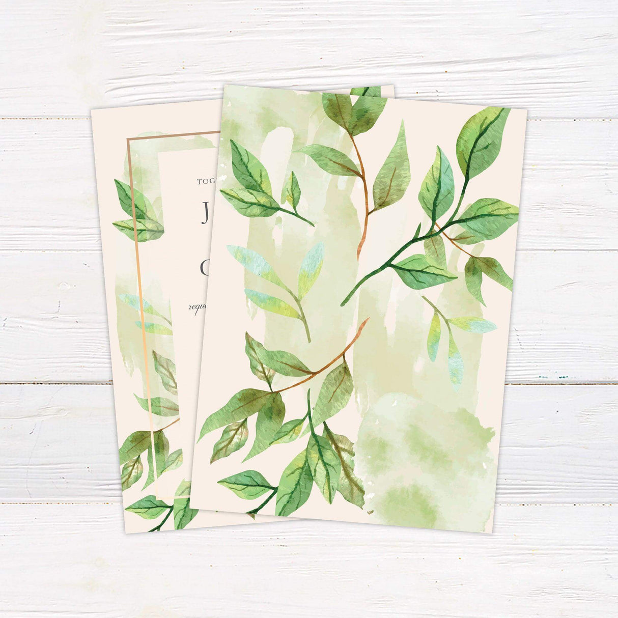 Wedding invitation with green watercolor leaves, elegant serif and script fonts, and a light cream background framed with a peach-gold border - back