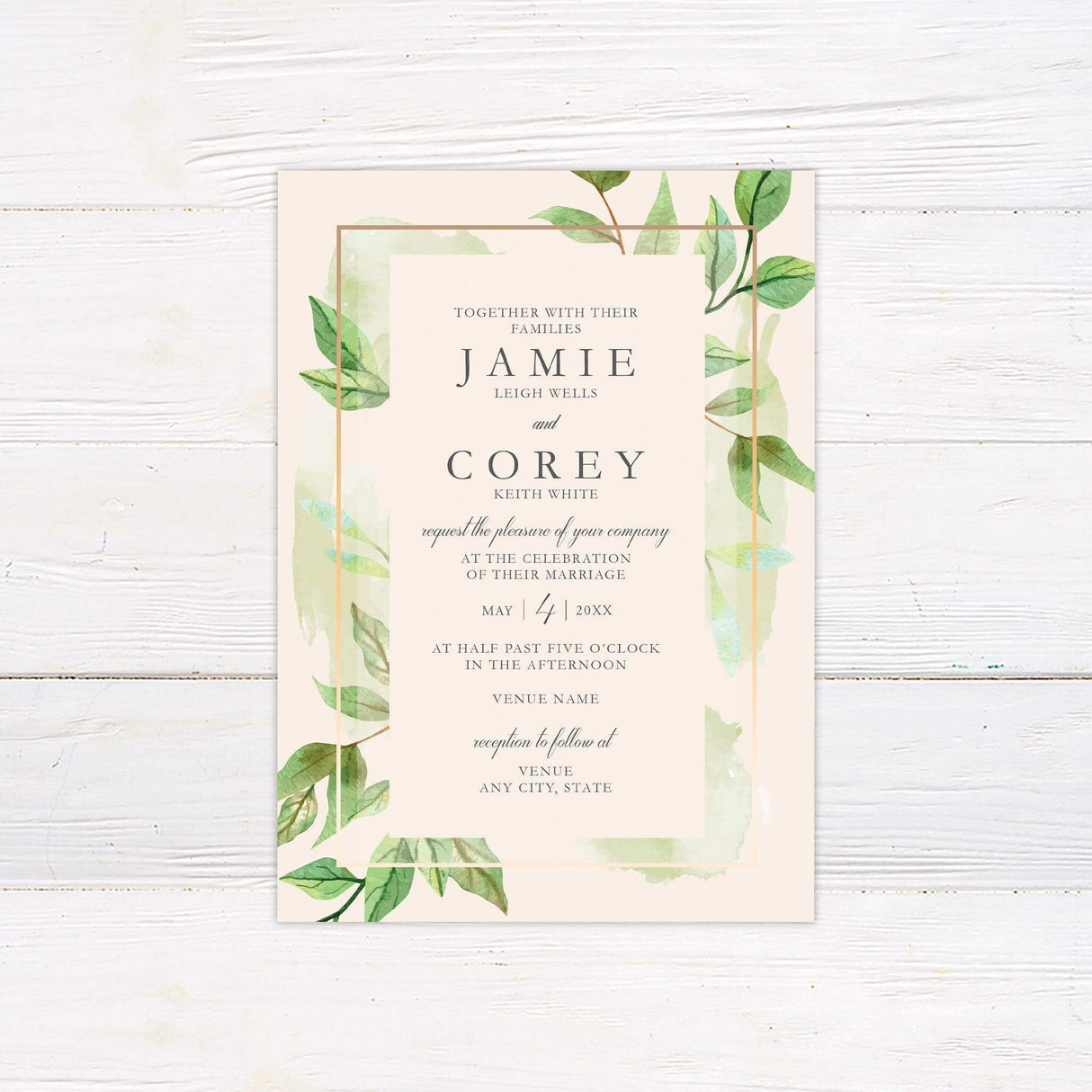 Wedding invitation with green watercolor leaves, elegant serif and script fonts, and a light cream background framed with a peach-gold border