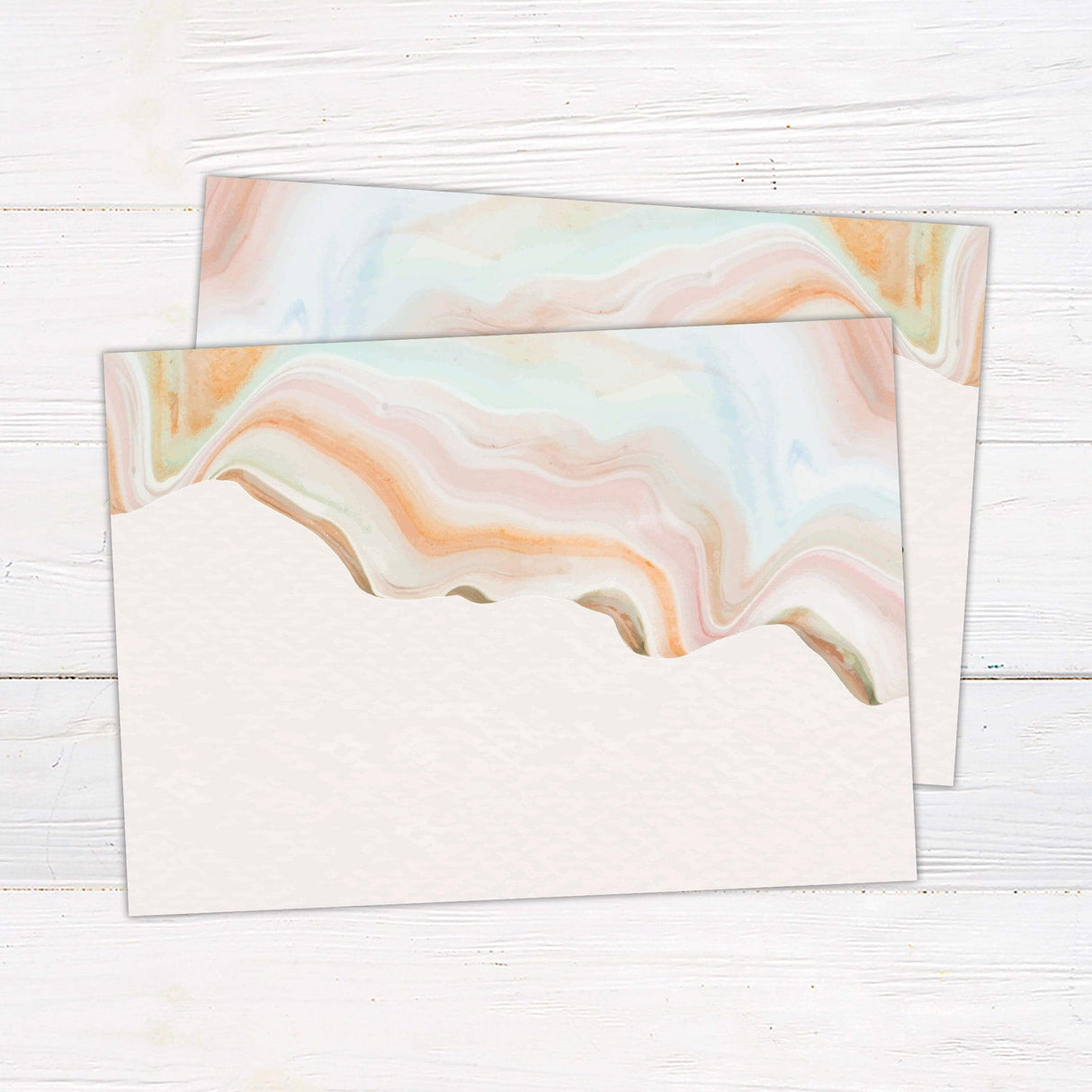 Modern pastel marbled wedding invitation with desert-inspired swirls of peach, green, and blush tones, featuring elegant serif and script fonts. back
