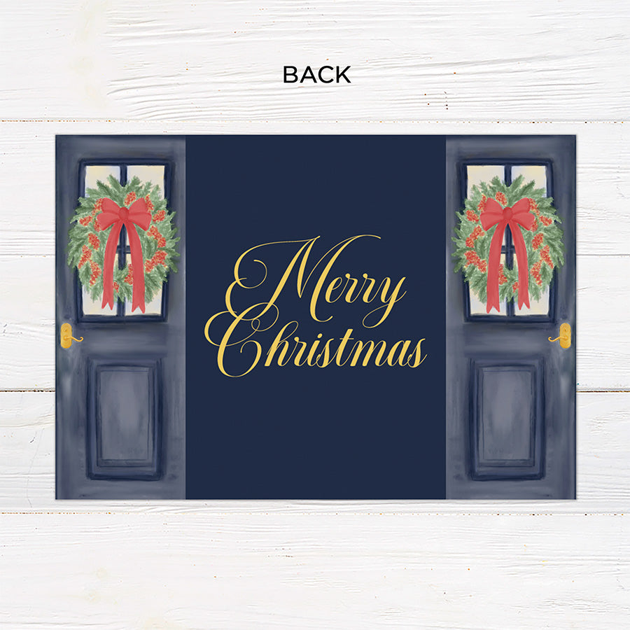 Personalized Doorway to Christmas gatefold card featuring navy blue doors decorated with festive evergreen wreaths, red bows, and elegant gold Merry Christmas lettering. The doors open to reveal a family photograph with a customizable holiday greeting and family name. - back.