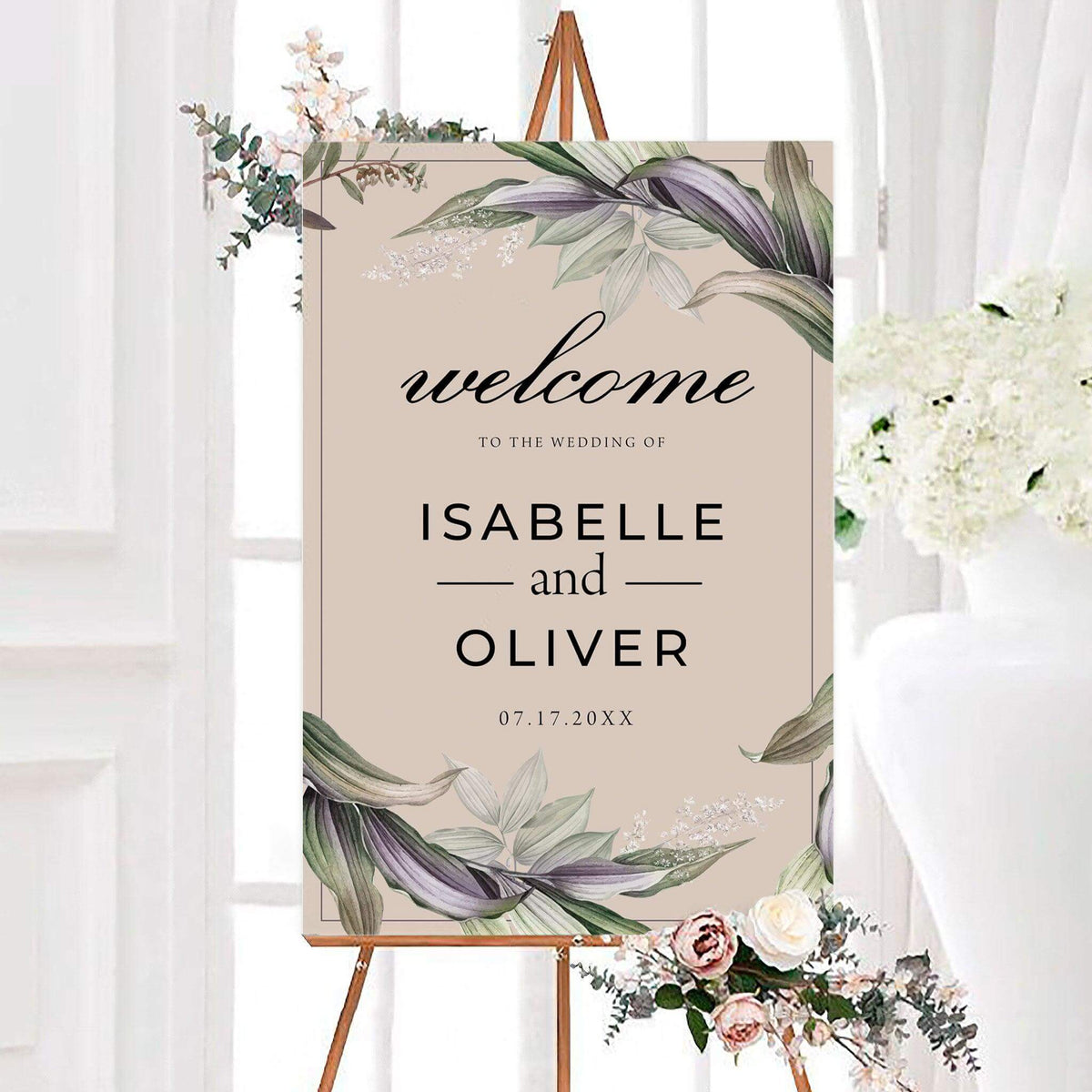 Personalized dreamy floral wedding welcome sign with watercolor leaves and delicate floral accents around the border. The sign features elegant script, the couple’s names, and their wedding date.