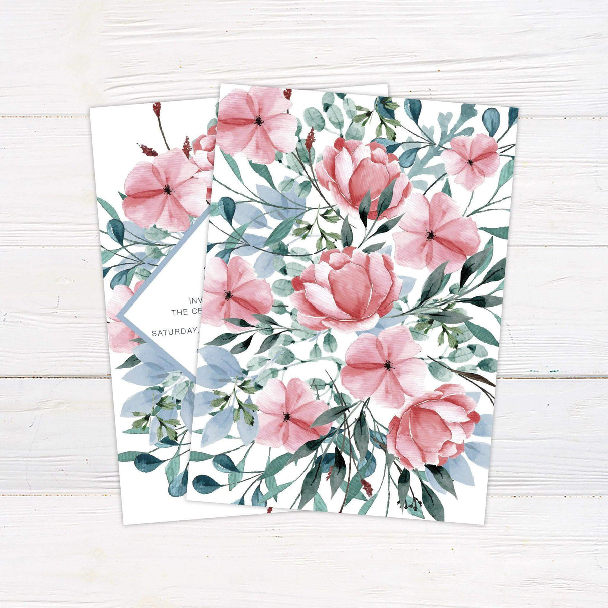 Wedding invitation with dusty blue diamond frame, blush pink watercolor flowers, and greenery on white background with elegant typography - back