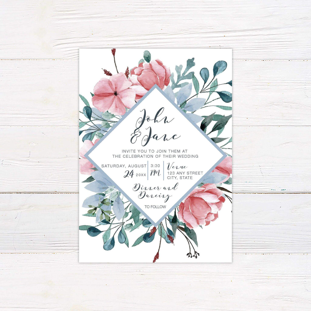 Wedding invitation with dusty blue diamond frame, blush pink watercolor flowers, and greenery on white background with elegant typography