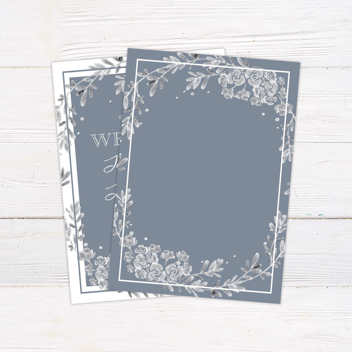 Dusty blue wedding invitation with gray watercolor floral wreath, elegant script typography, and slate blue background - back