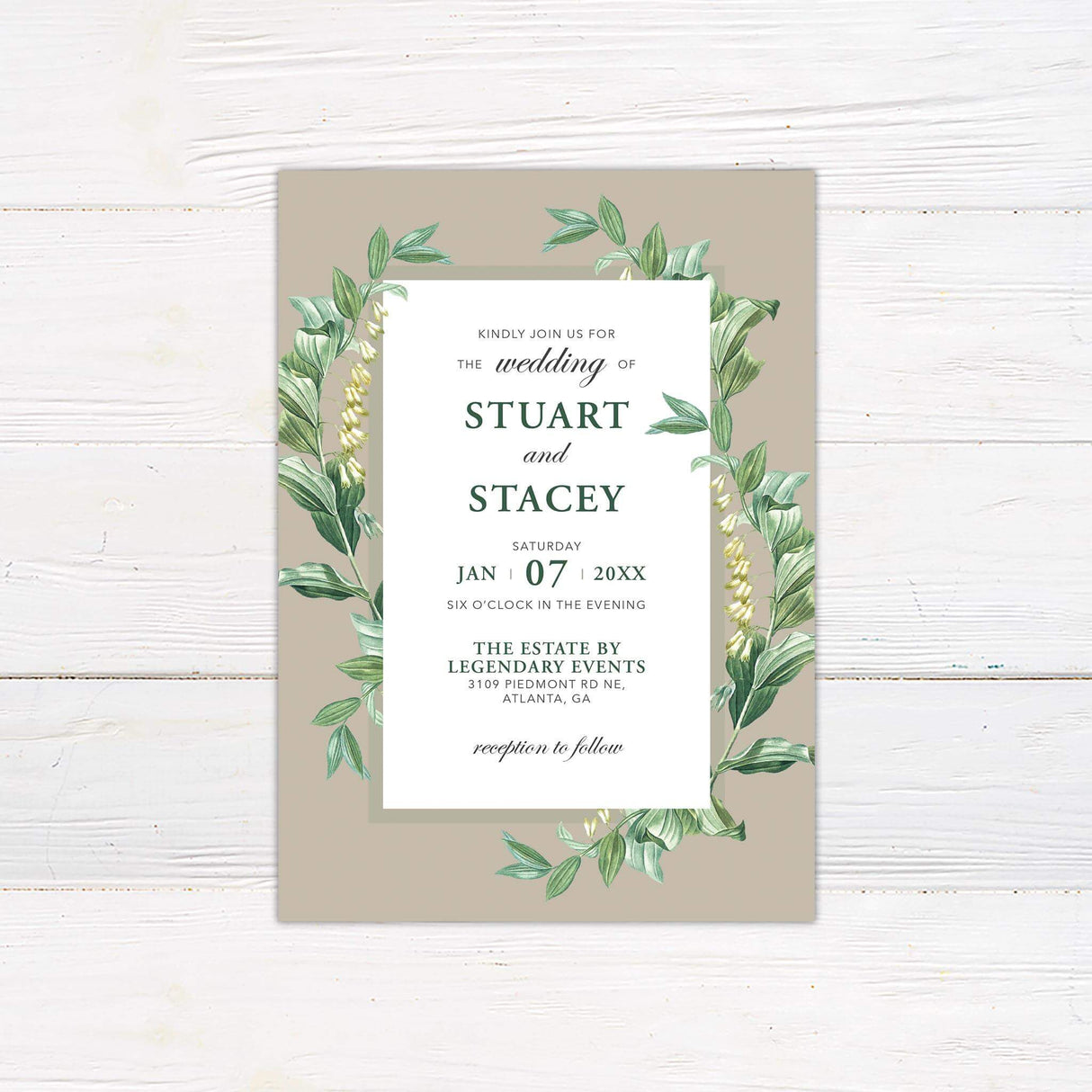 Elegant wedding invitation with green watercolor botanical border, taupe background, serif and script text, and minimalist layout