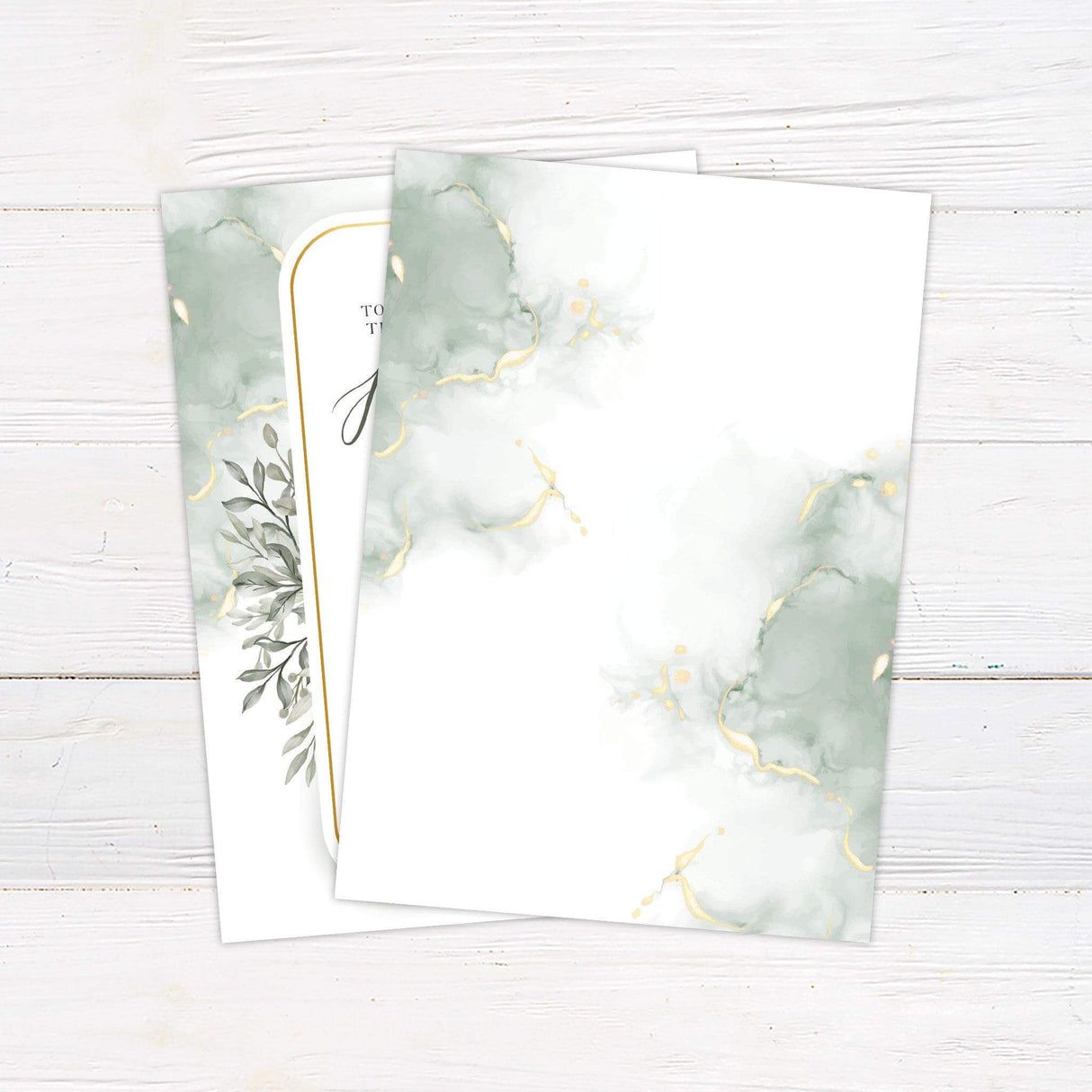 Elegant wedding invitation with sage green watercolor leaves, gold border, and romantic script on white background - back