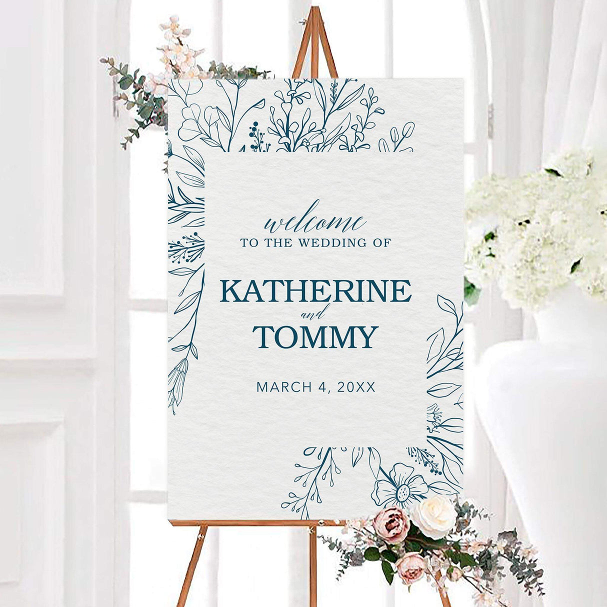 Elegant indigo floral wedding welcome sign featuring indigo line art flowers, leaves, and botanical branches around a lightly textured background. The personalized design displays the couple’s names and wedding date with classic serif and script lettering.