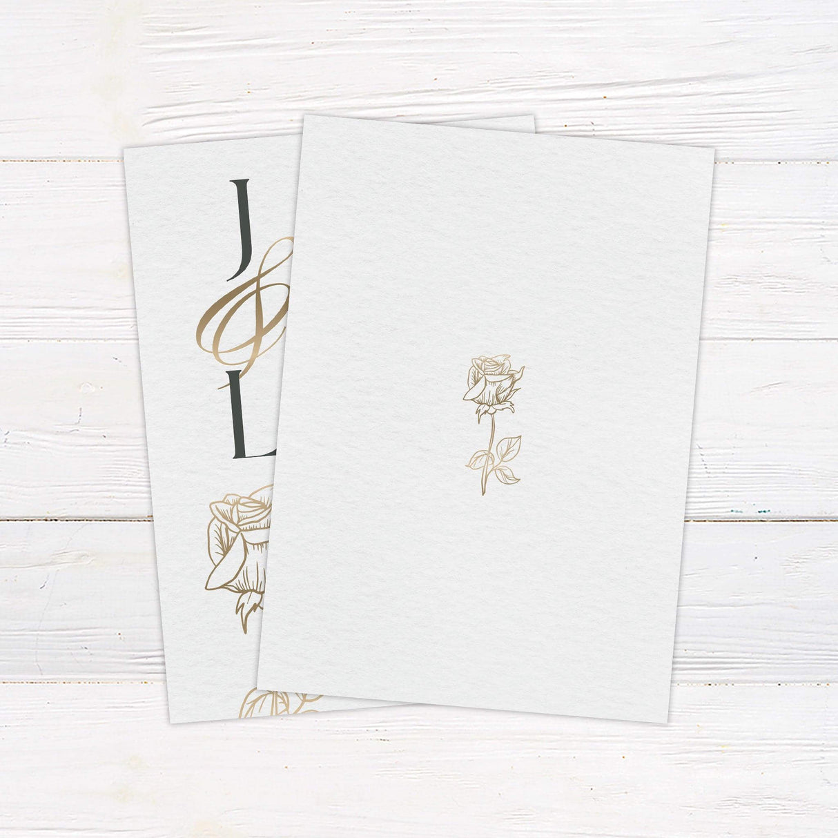Monogram wedding invitation with gold initials, rose illustration, and serif typography on soft textured background - back