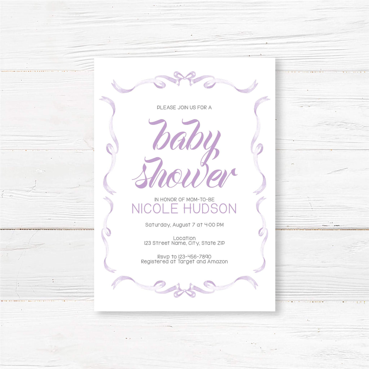Elegant Ribbons Baby Shower Invitation with hand-lettered script and whimsical ribbon border on a wood background.