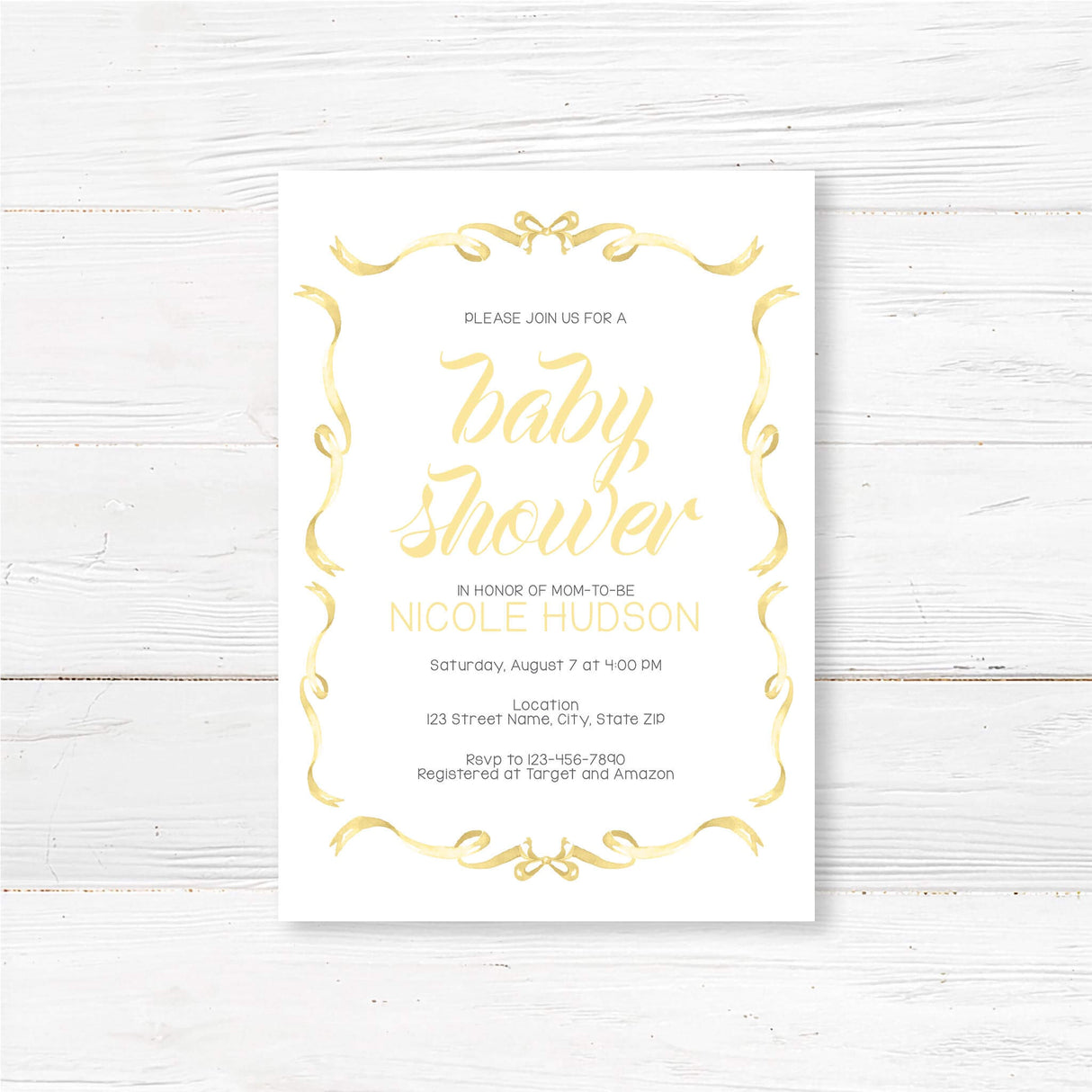 Elegant Ribbons Baby Shower Invitation with gold hand-lettered script and ribbon border on wood background, celebrating mom-to-be Nicole.