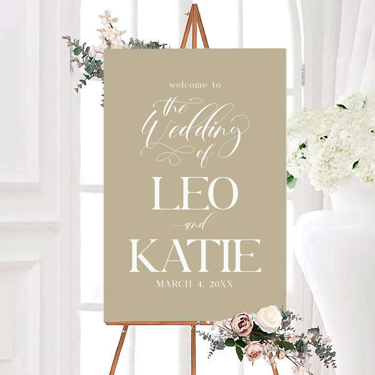 Elegant Script wedding welcome sign featuring elegant white script and bold serif typography on a neutral background. The personalized sign displays the couple’s names and wedding date in a sophisticated vertical layout.