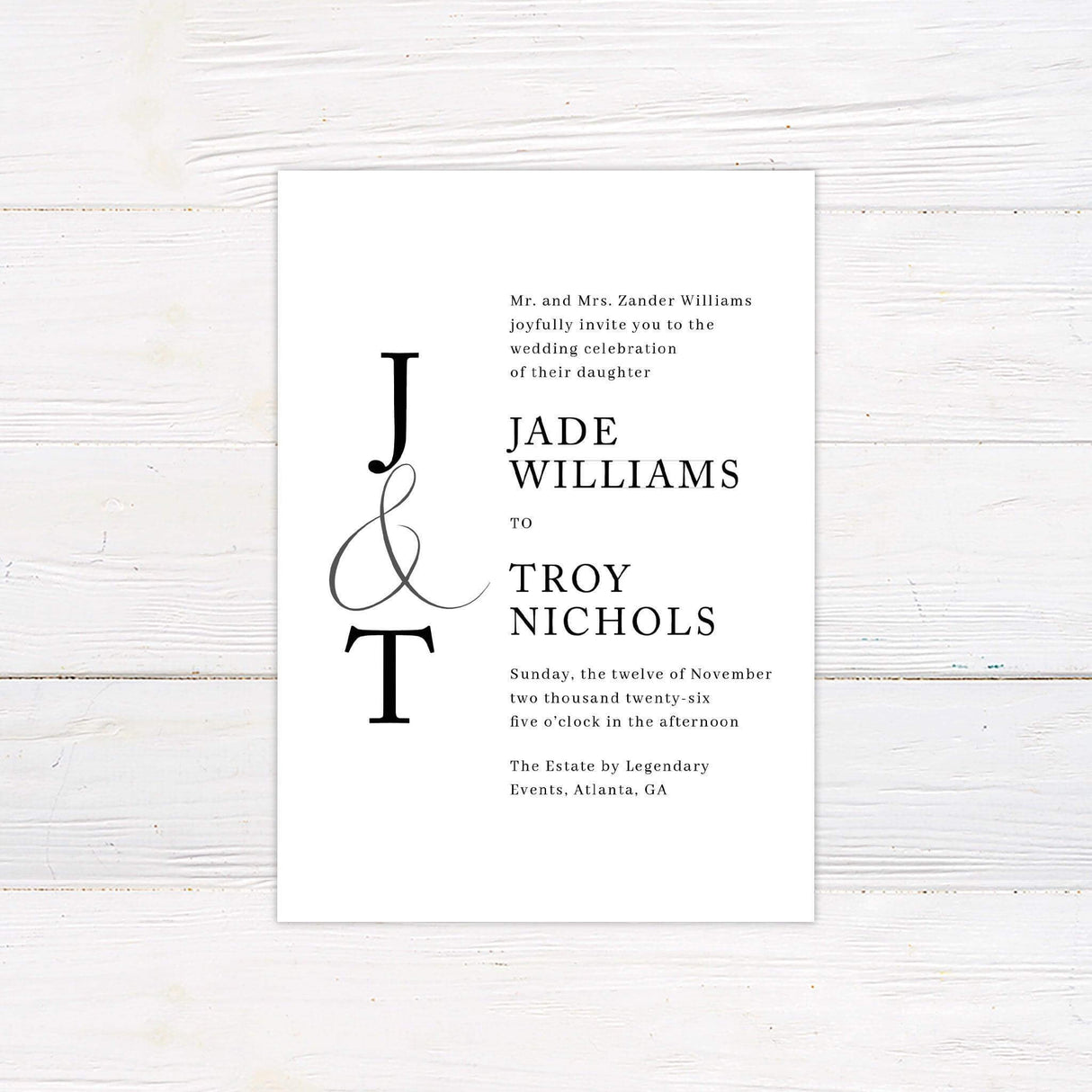 Minimalist wedding invitation with black serif typography and monogram initials on a clean white background