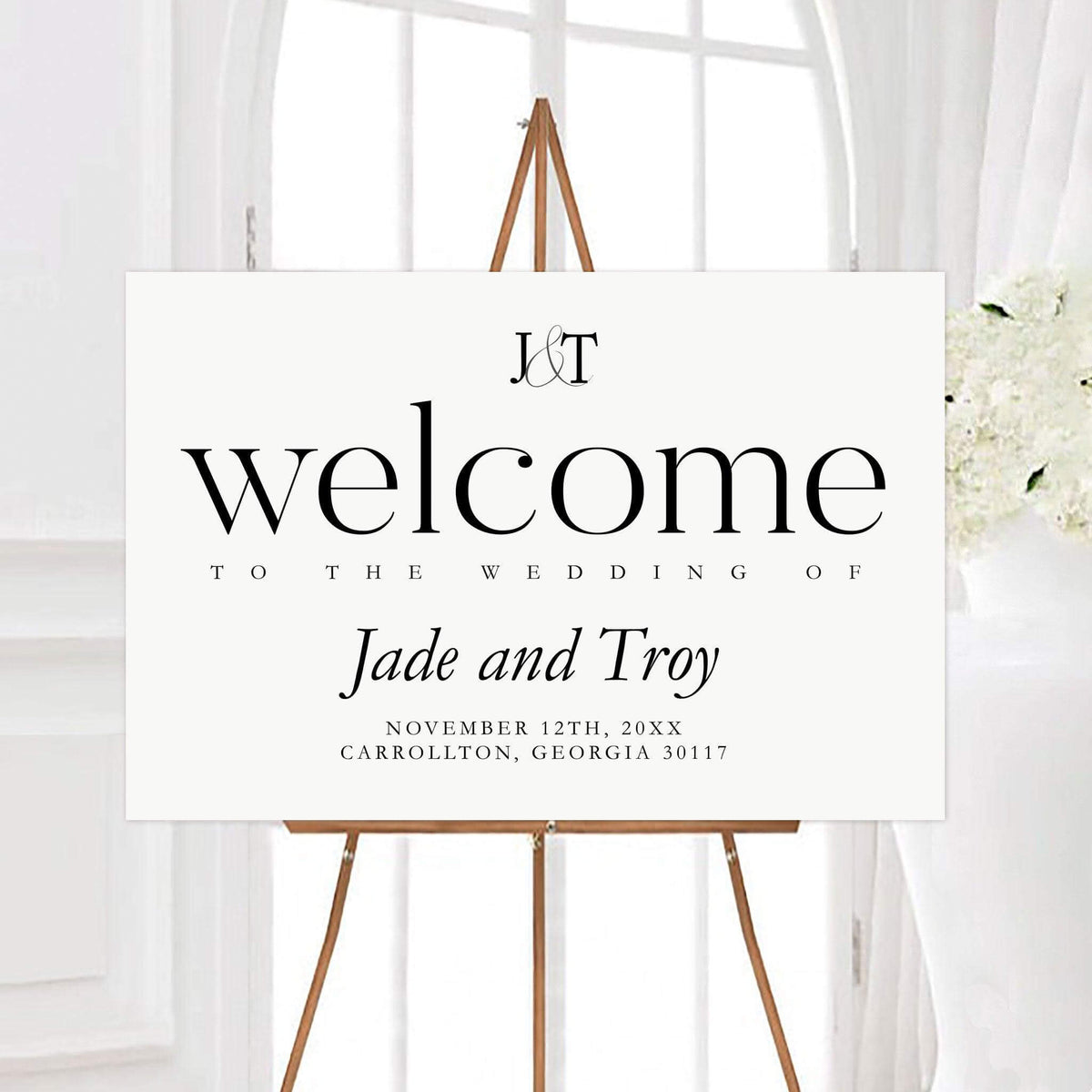 Elegant and simple wedding welcome sign featuring a personalized monogram, couple’s names, wedding date, and location. Classic black typography creates a clean and timeless wedding entrance display.