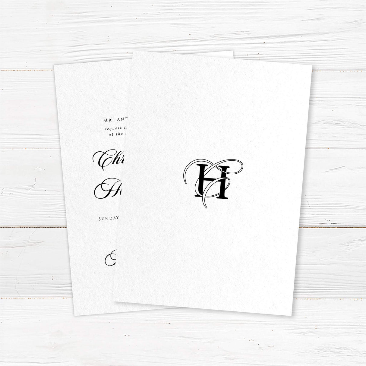 Elegant black and white wedding invitation with entwined initials monogram and formal typography - back side
