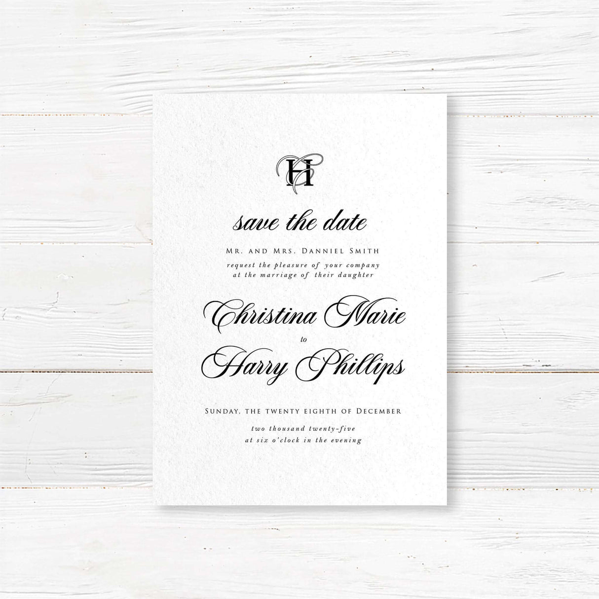 Black and white Save the Date card with elegant monogram and classic script and serif fonts printed on textured cardstock