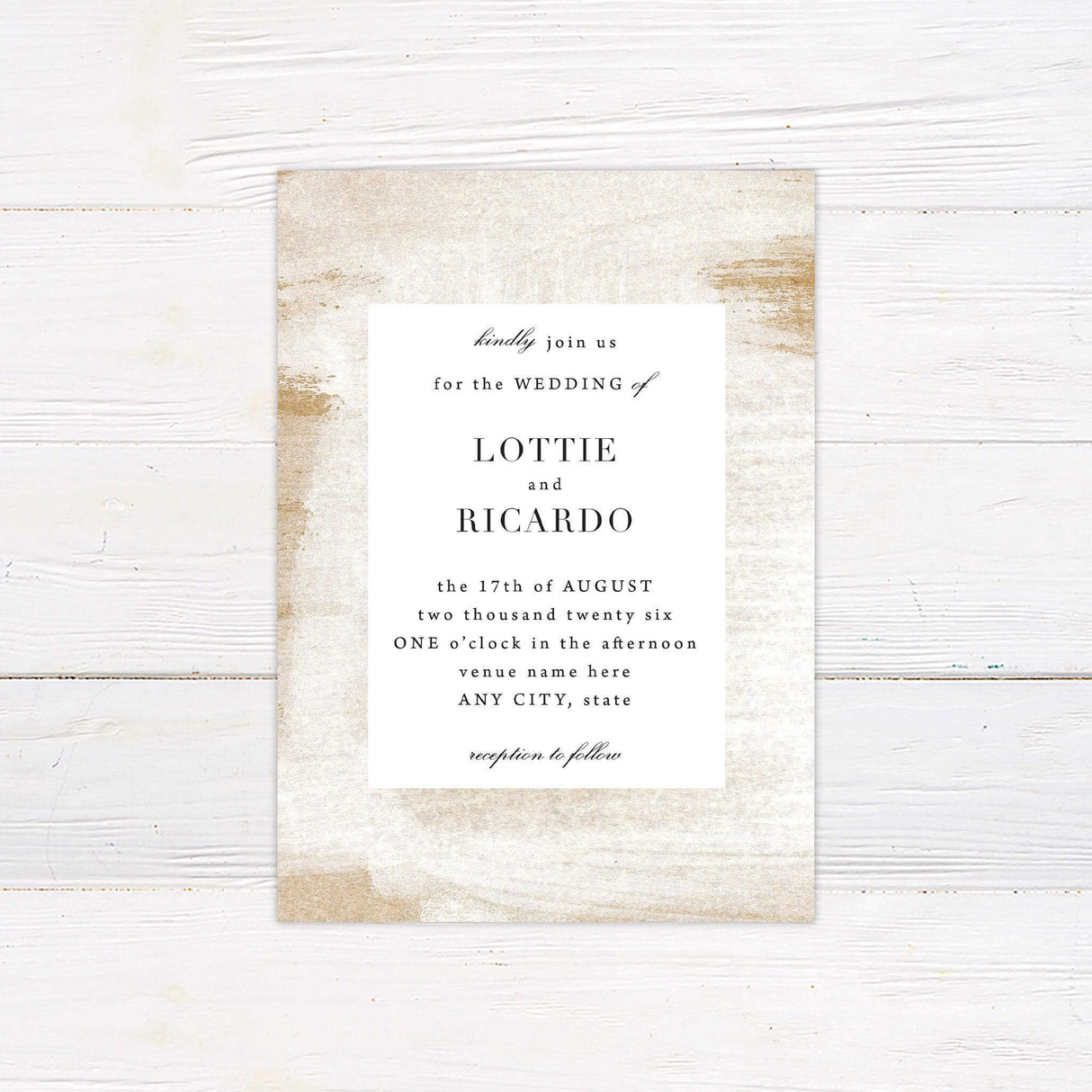 Minimalist wedding invitation with white center panel, soft beige and gold sand-textured background, and elegant serif fonts on a neutral-toned design.