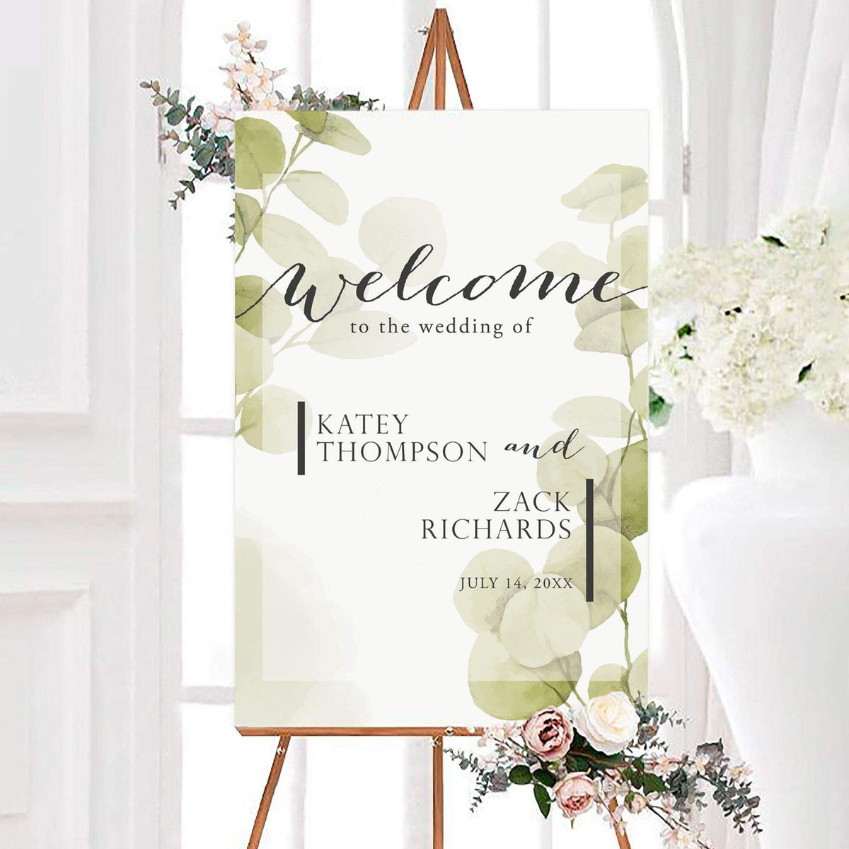 Personalized eucalyptus mist wedding welcome sign featuring soft watercolor eucalyptus leaves and elegant typography. The botanical design displays the couple’s names and wedding date.