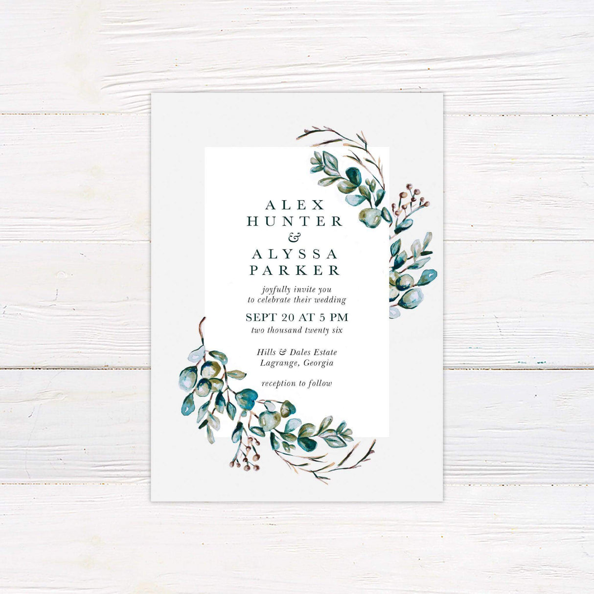 Wedding invitation with watercolor eucalyptus wreath, elegant serif text, and botanical accents, ideal for rustic, garden, or nature-themed weddings.
