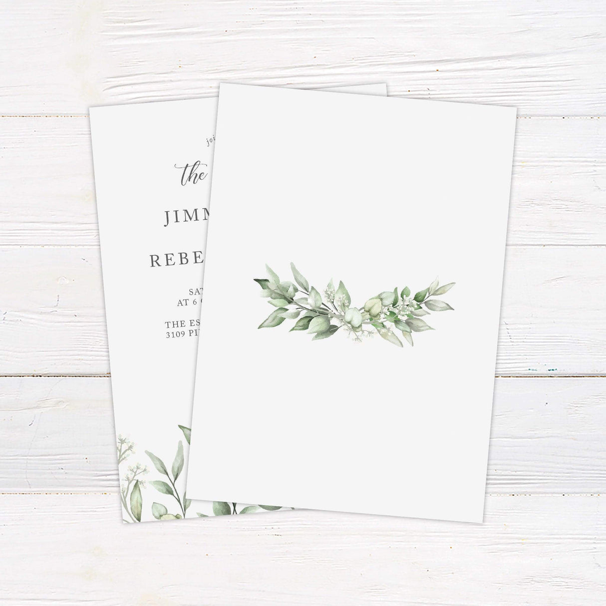 Wedding invitation with watercolor eucalyptus leaves and elegant script layout, featuring muted green foliage along the bottom and classic text centered above - back