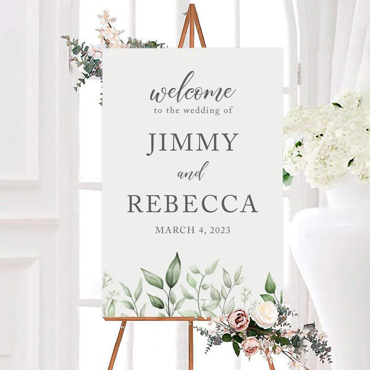 Minimal faded eucalyptus leaves wedding welcome sign featuring soft watercolor eucalyptus leaves and greenery along the bottom. The personalized design includes the couple’s names and wedding date in elegant gray script and serif lettering.
