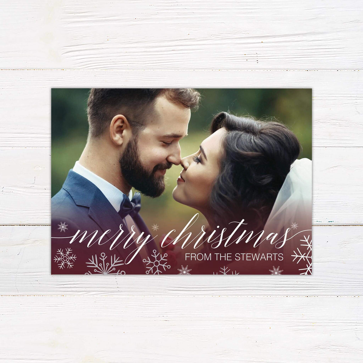Custom holiday card design featuring a full photo background with elegant snowflake accents, script typography, and space for a personalized family greeting.