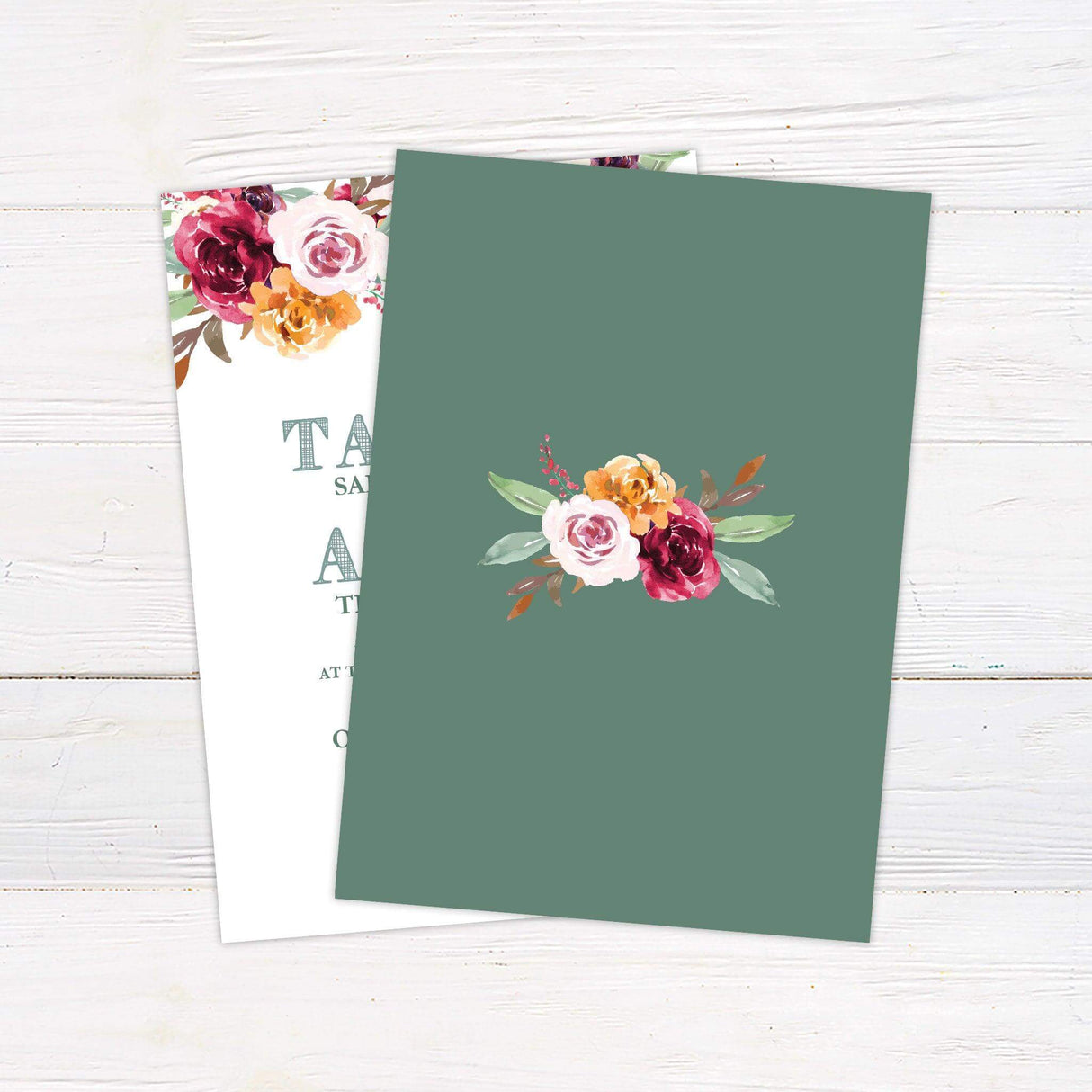 Wedding invitation with bold serif text and watercolor florals in burgundy, peach, and rust tones arranged along the top edge - back