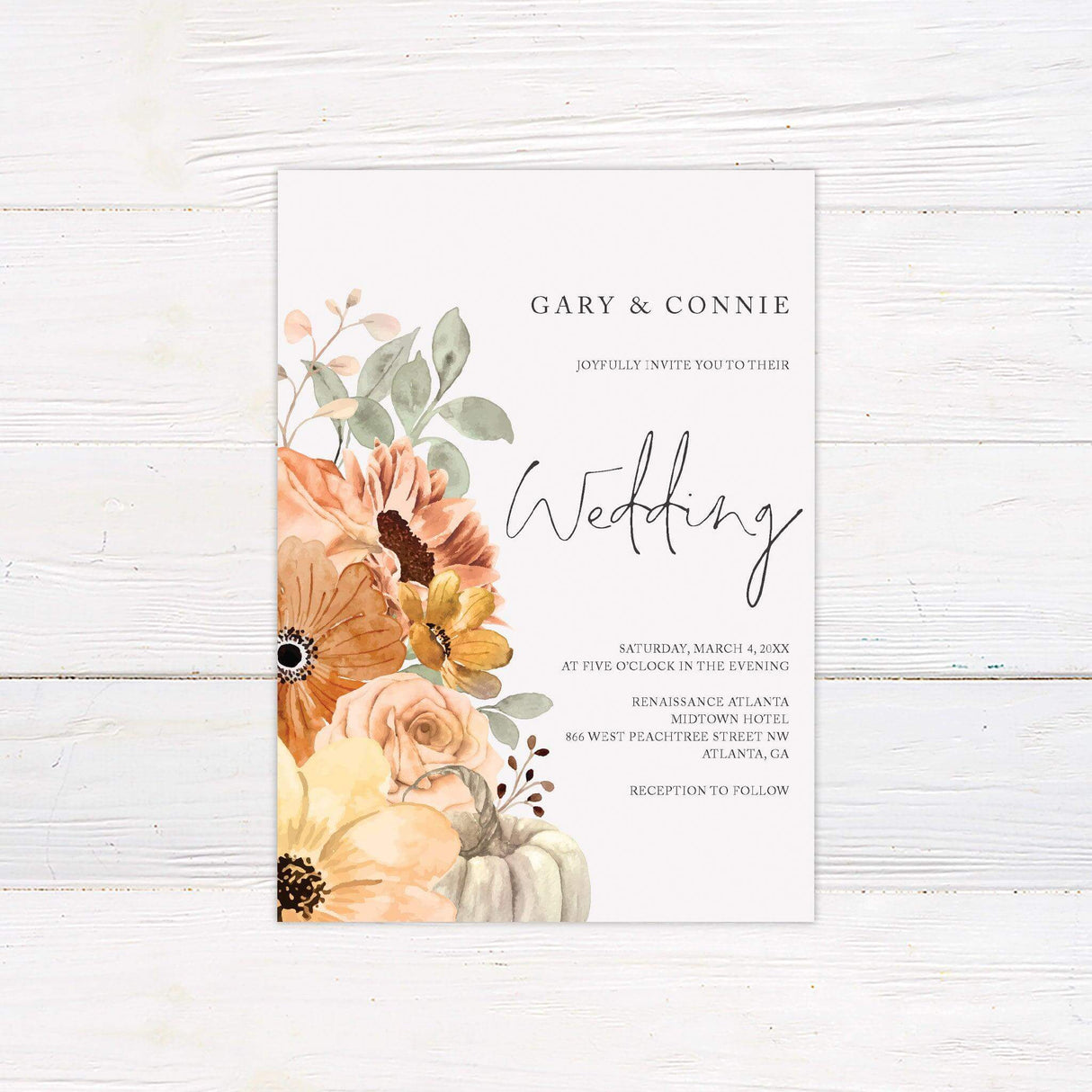 Fall wedding invitation with watercolor florals in orange and yellow tones, eucalyptus greenery, and a white pumpkin on a minimalist background