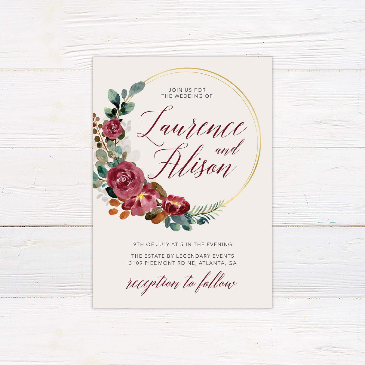 Wedding invitation with burgundy floral watercolor wreath, gold arc detail, and elegant script and serif text on a cream background