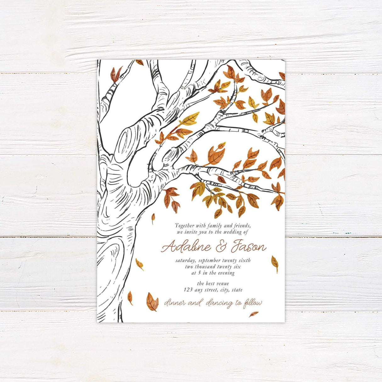 Rustic wedding invitation featuring a hand-drawn fall tree with watercolor leaves in autumn colors and elegant handwritten script.