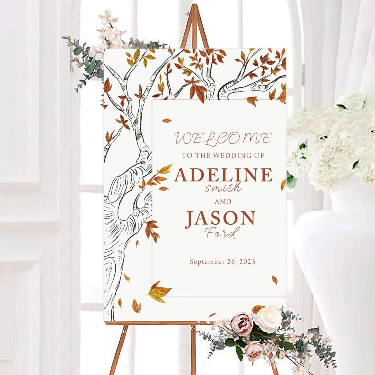 Personalized fall tree wedding welcome sign featuring an illustrated tree and scattered autumn leaves. The design includes the couple’s names and wedding date in elegant typography.