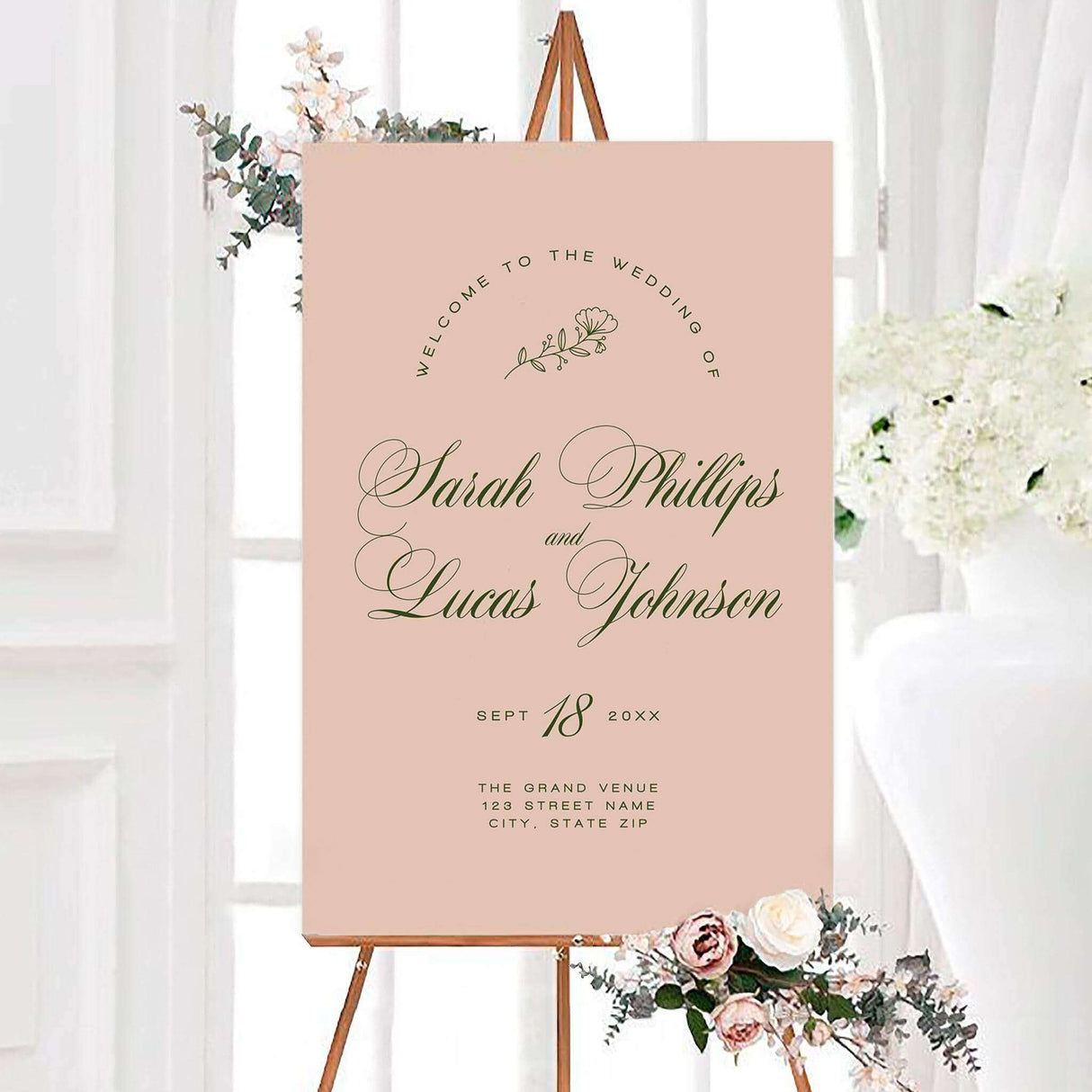 Blush pink welcome sign with elegant green script font, minimal floral accent, and classic layout.