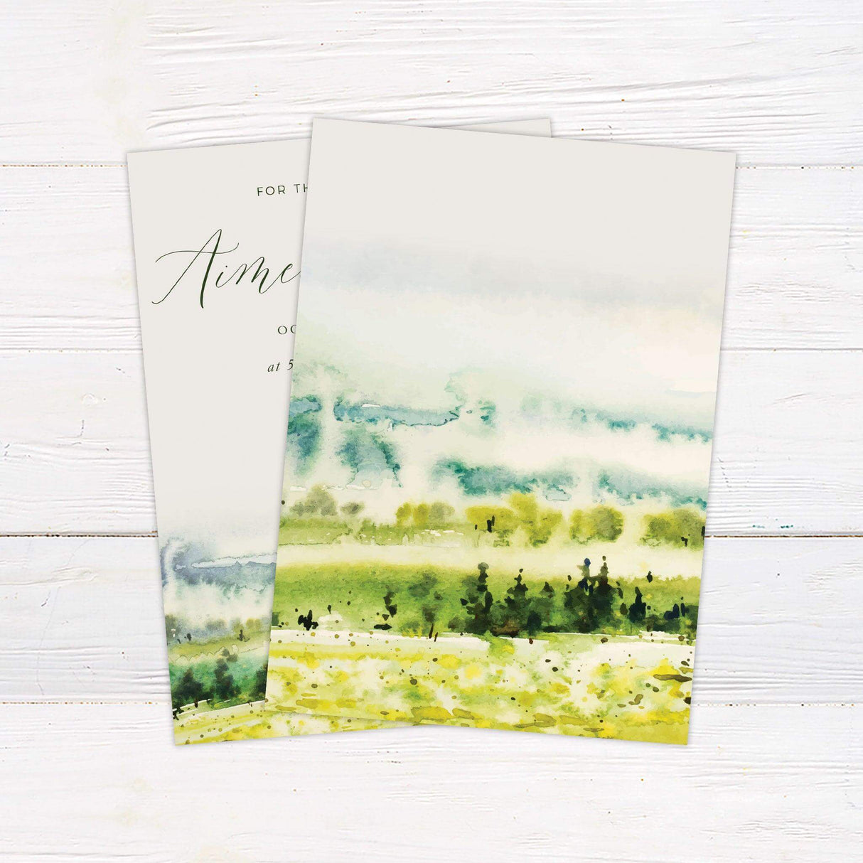 Elegant rustic wedding invitation with watercolor farmland landscape and green calligraphy for countryside-themed weddings. back