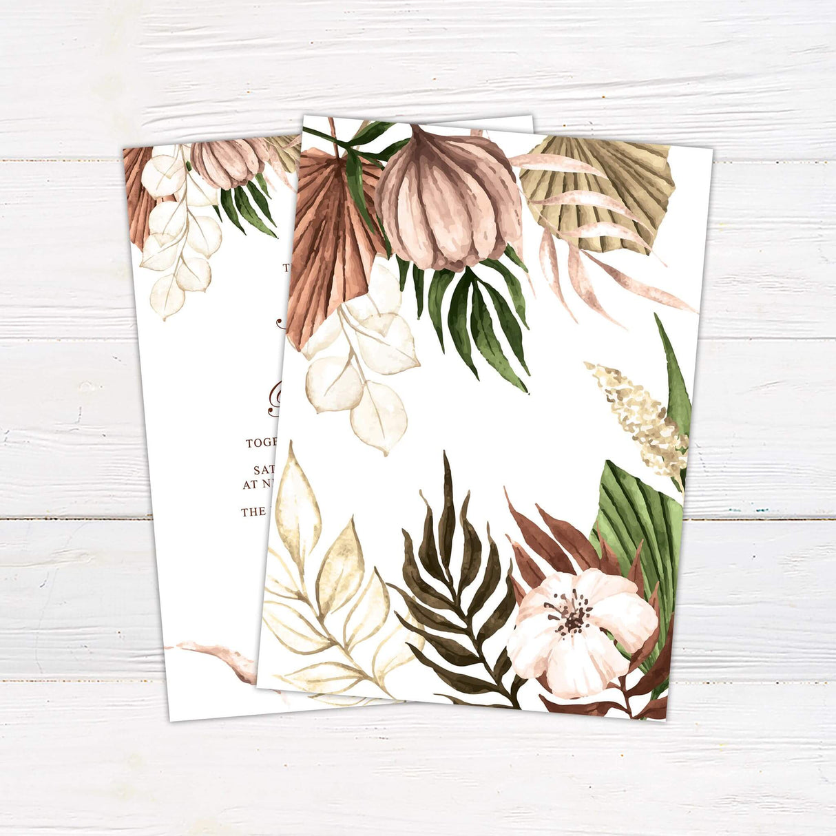 A wedding invitation with a soft cream background features elegant watercolor floral and botanical elements in warm earthy tones of beige, brown, and green. The text is arranged in a mix of flowing script and serif fonts, creating a timeless and sophisticated look. Event details, including the date, time, venue, and dress code, are clearly displayed in a balanced layout. This design exudes rustic elegance, perfect for boho, nature-inspired, or outdoor wedding celebrations. Back.