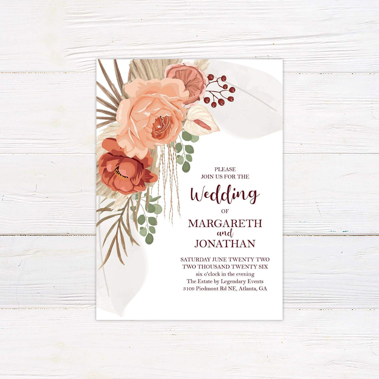 Boho wedding invitation with terracotta flowers, pampas grass, and modern fonts on a white background, ideal for rustic or desert-themed weddings