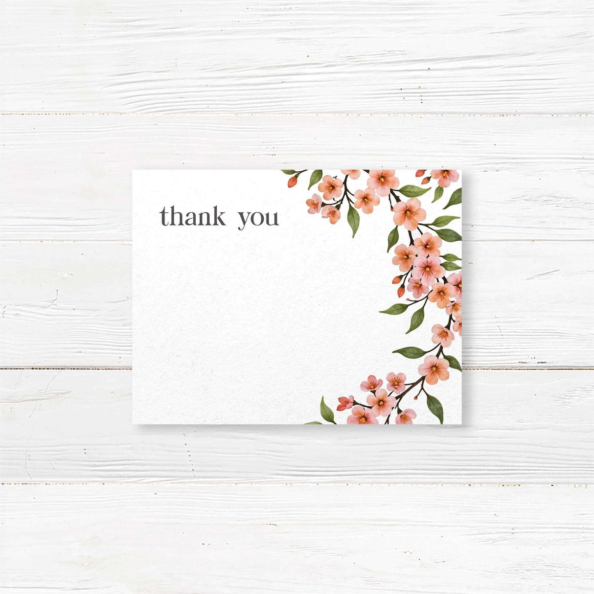 Bridal shower thank-you card featuring a watercolor cherry blossom vine with soft pink flowers and green leaves, printed on premium cardstock.