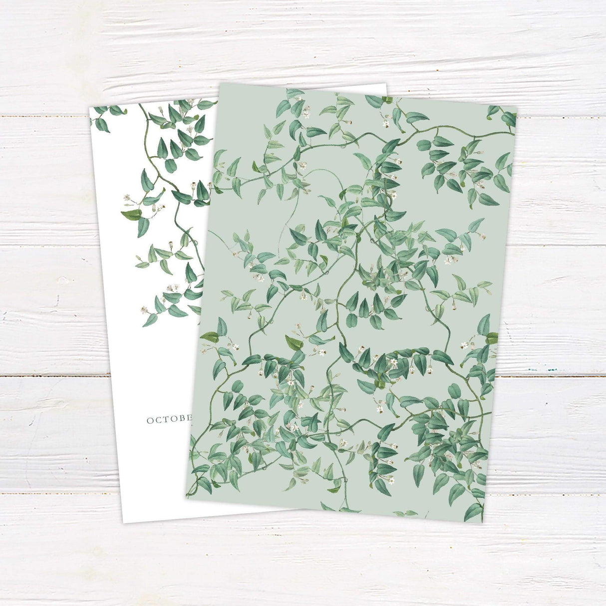 Elegant wedding invitation featuring a watercolor flowering vine design with delicate green leaves and minimalist calligraphy. back